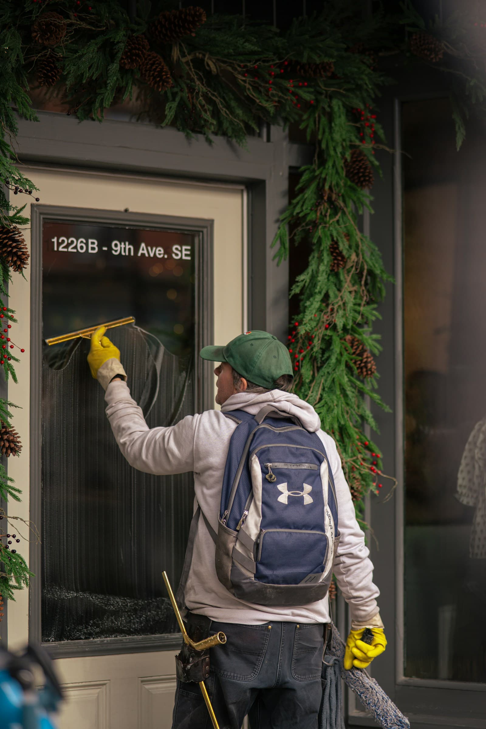 A window-cleaning professional working at a customer property